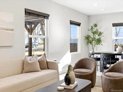 a living room with furniture and a potted plant