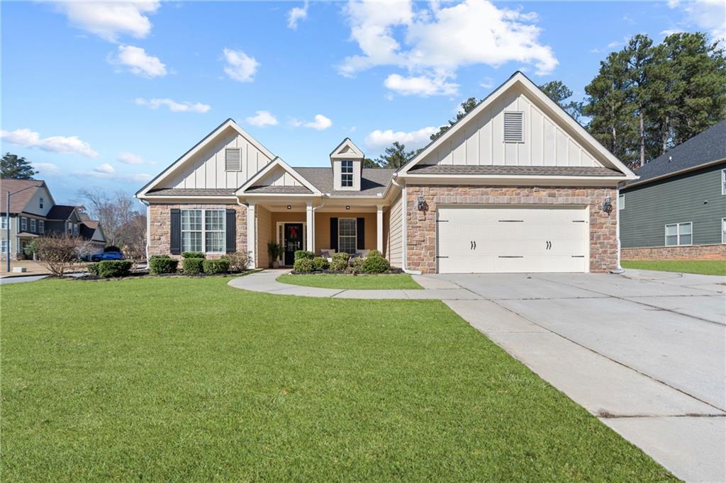 a front view of a house with a yard and trees