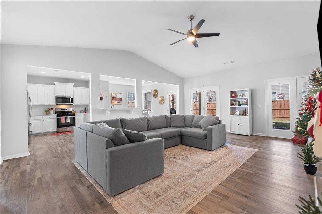 2190 Leatherstone Drive Powder Springs, GA 30127 - Photo 15 of 38 a living room with furniture kitchen view and a wooden floor