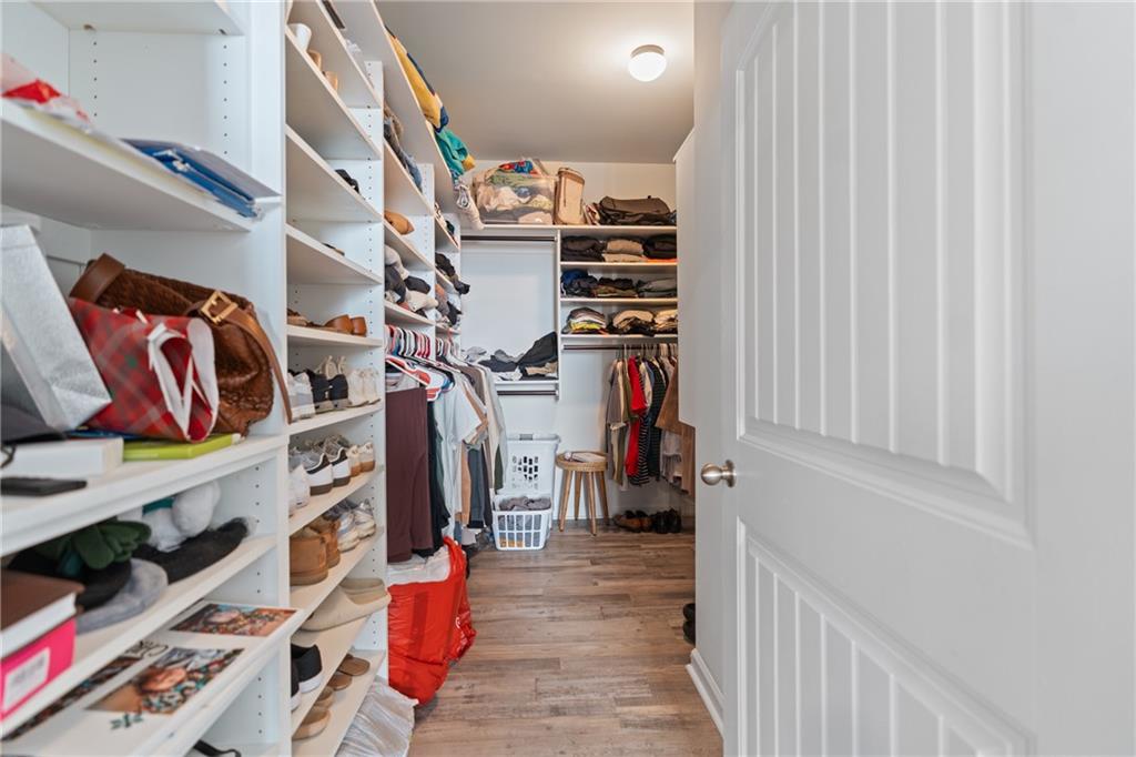 2190 Leatherstone Drive Powder Springs, GA 30127 - Photo 19 of 38 a view of walk in closet with clothes and shoes