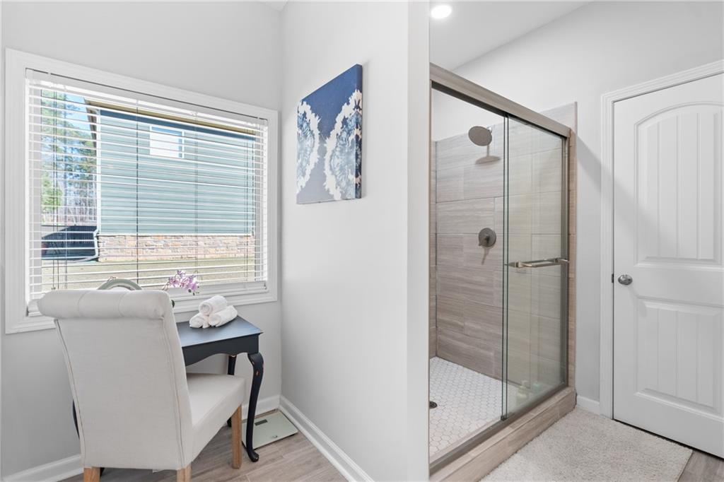2190 Leatherstone Drive Powder Springs, GA 30127 - Photo 21 of 38 a bathroom with a granite countertop sink a mirror and a shower
