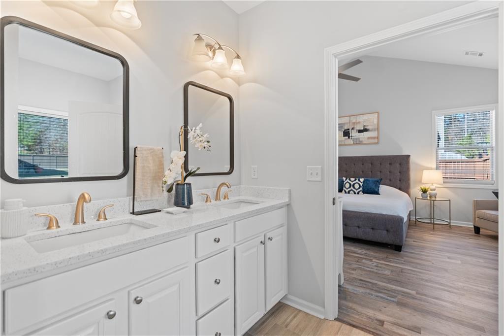 2190 Leatherstone Drive Powder Springs, GA 30127 - Photo 22 of 38 a en suite bathroom with double vanity sinks and a mirror