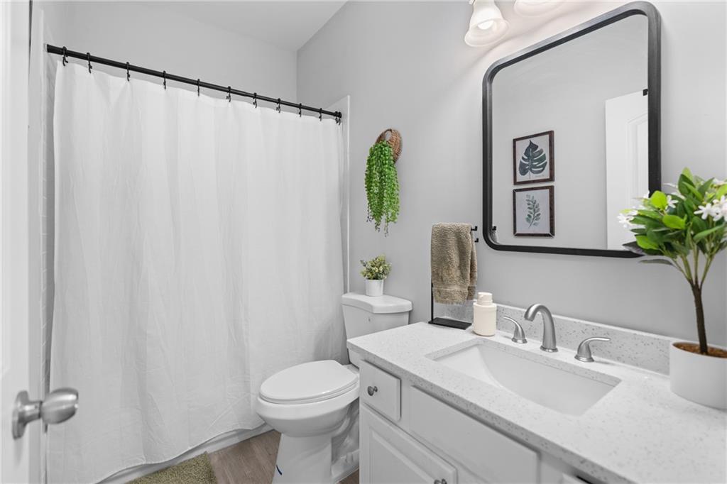 2190 Leatherstone Drive Powder Springs, GA 30127 - Photo 23 of 38 a bathroom with a sink vanity mirror and toilet