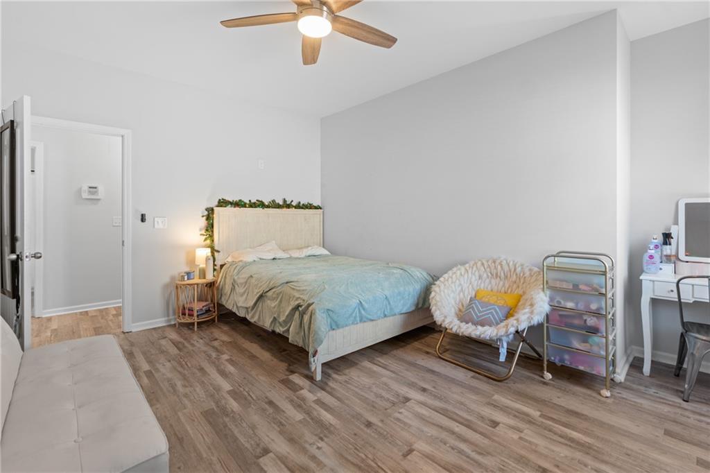 2190 Leatherstone Drive Powder Springs, GA 30127 - Photo 27 of 38 a bedroom with a bed a chandelier and closet