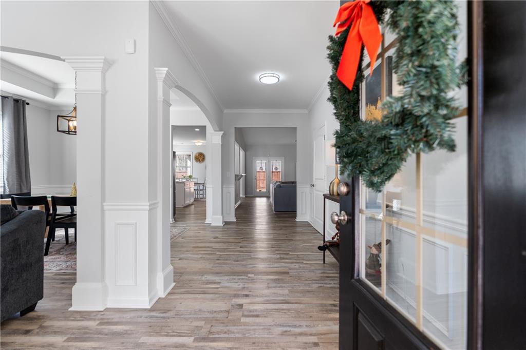 2190 Leatherstone Drive Powder Springs, GA 30127 - Photo 3 of 38 a view of a hallway with wooden floor and livingroom with furniture