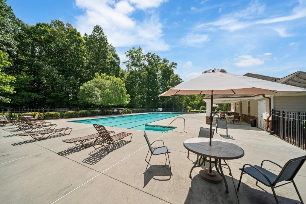 2190 Leatherstone Drive Powder Springs, GA 30127 - Photo 37 of 38 a view of backyard with table and chairs under an umbrella