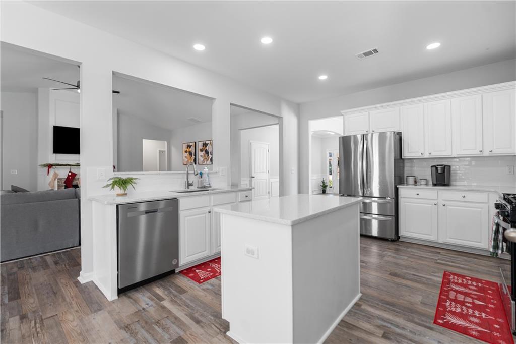 2190 Leatherstone Drive Powder Springs, GA 30127 - Photo 7 of 38 a kitchen with white cabinets and stainless steel appliances