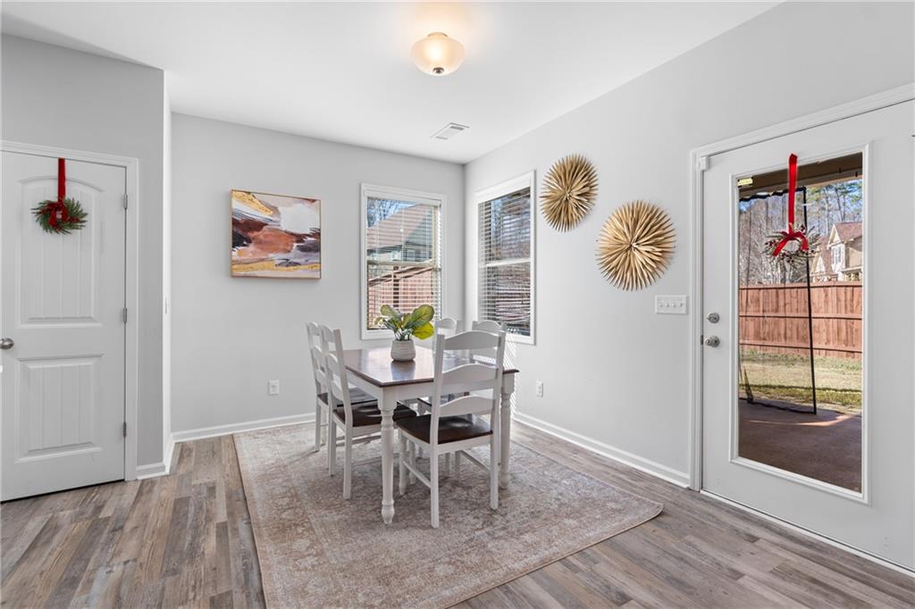 2190 Leatherstone Drive Powder Springs, GA 30127 - Photo 8 of 38 a view of a dining room with furniture and wooden floor