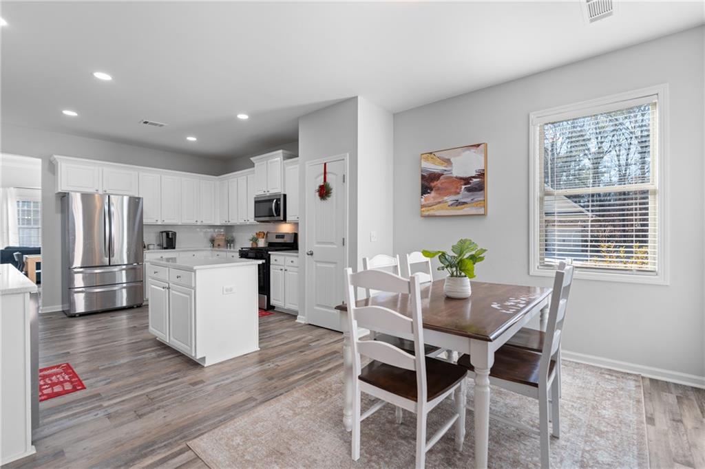 2190 Leatherstone Drive Powder Springs, GA 30127 - Photo 9 of 38 a view of kitchen with refrigerator and wooden floor
