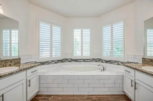 a spacious bathroom with sinks and a bathtub