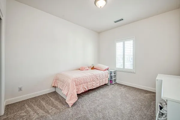 a room with a bed and a window