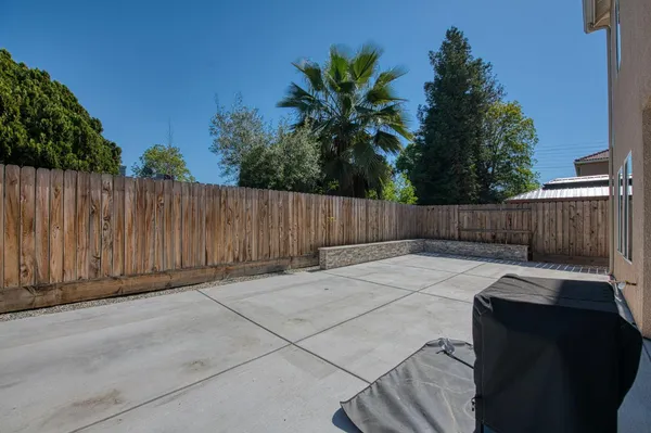 a view of a backyard with wooden fence