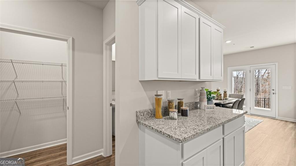 241 Sound Circle Stockbridge, GA 30281 - Photo 27 of 70 a kitchen with stainless steel appliances granite countertop a sink and cabinets with granite countertops