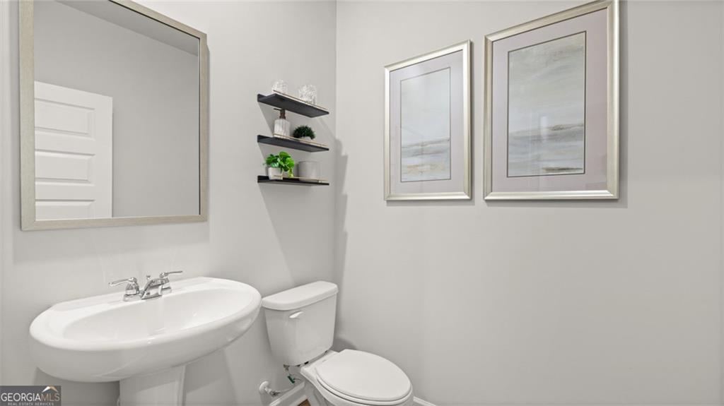 241 Sound Circle Stockbridge, GA 30281 - Photo 29 of 70 a bathroom with a sink toilet and mirror