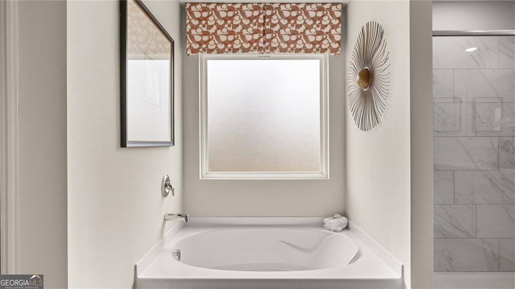 241 Sound Circle Stockbridge, GA 30281 - Photo 52 of 70 a white bath tub sitting next to a white sink