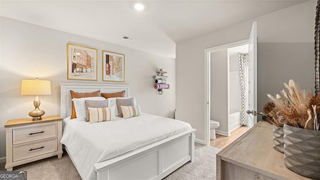 241 Sound Circle Stockbridge, GA 30281 - Photo 57 of 70 a bedroom with a bed and a couch