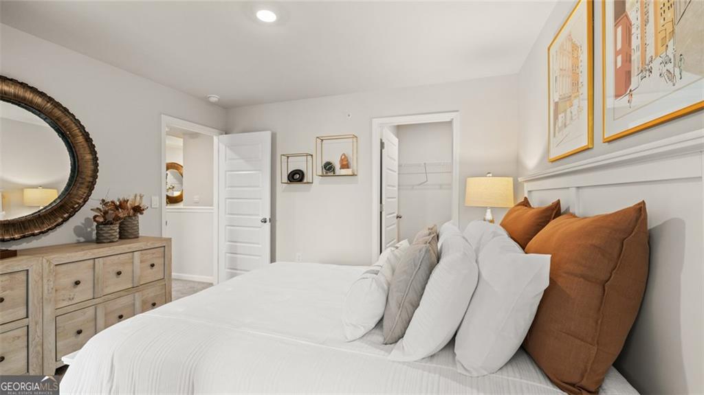 241 Sound Circle Stockbridge, GA 30281 - Photo 61 of 70 a bedroom with a bed a mirror and a window