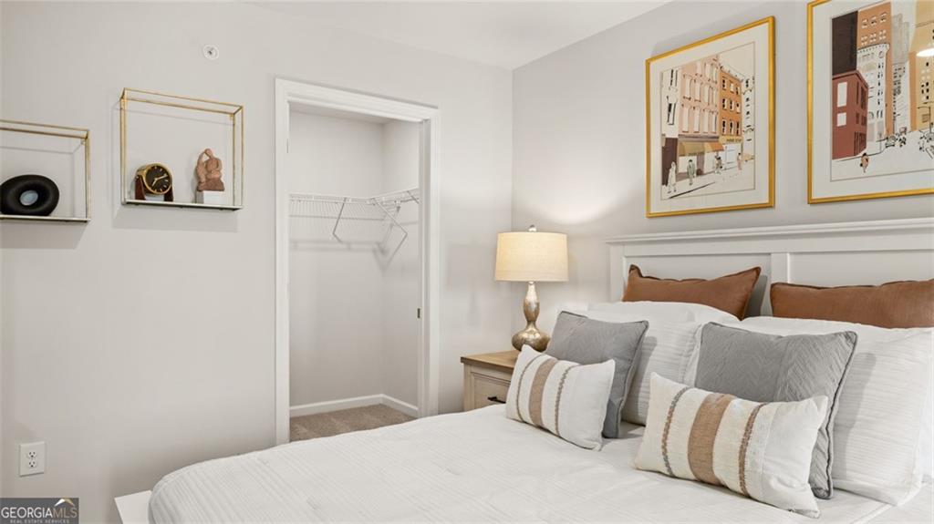 241 Sound Circle Stockbridge, GA 30281 - Photo 63 of 70 a bedroom with a bed and a painting on the wall