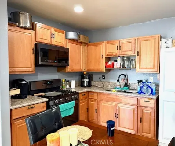 a kitchen with a sink a stove and window