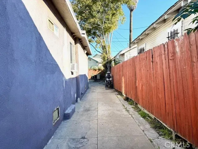 a view of a pathway of a building with wooden fence