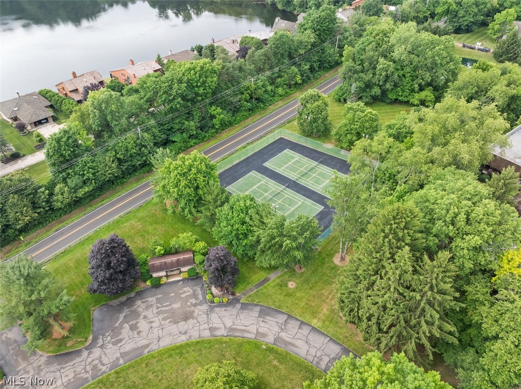 171 Granger Road, Unit 107 Medina, OH 44256 - Photo 41 of 41 Private tennis/pickleball courts set within a lush, tree-lined landscape.