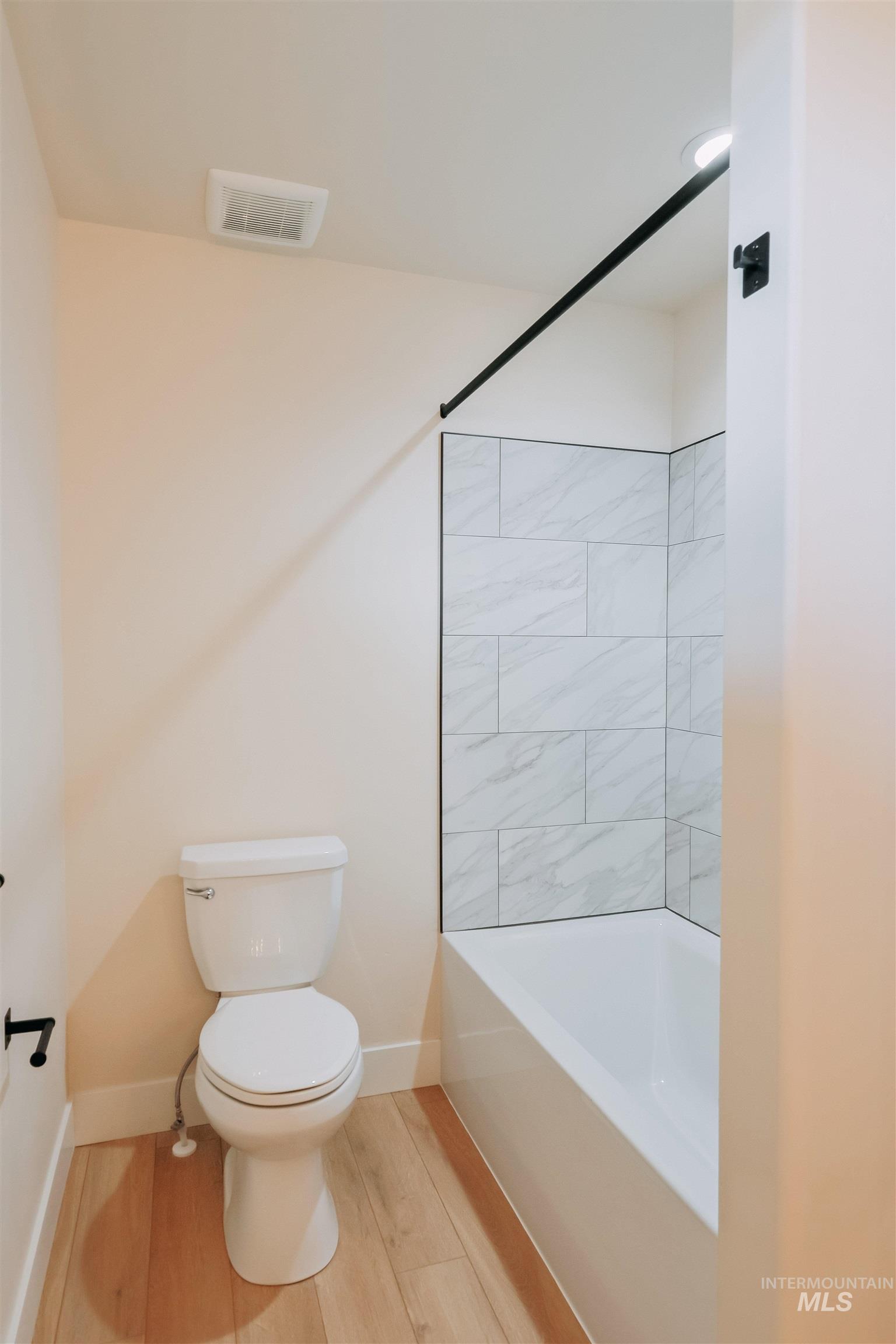 10 North Crk Way Cascade, ID 83611 - Photo 10 of 25 Bathroom featuring light wood-style flooring and shower / bath combination