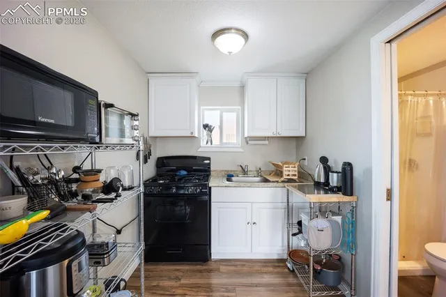 a kitchen with stainless steel appliances a stove a sink and a refrigerator