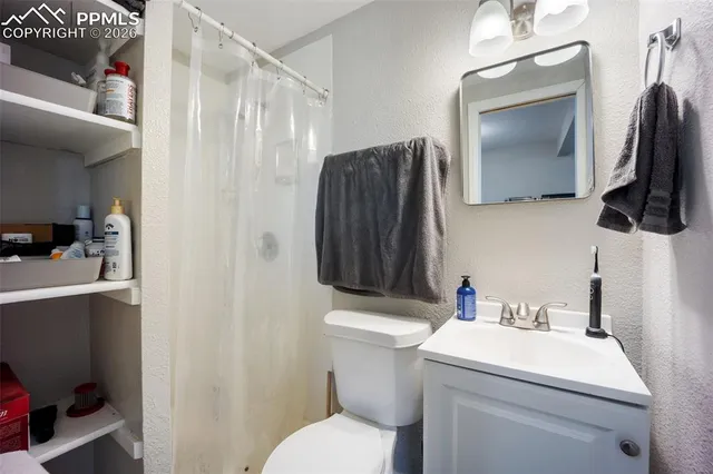 a bathroom with a sink toilet and mirror
