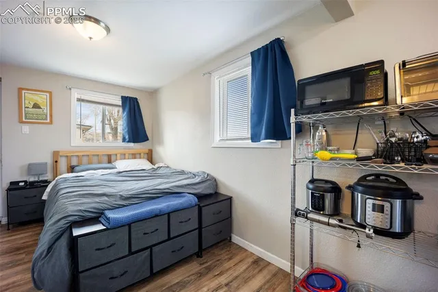 a bedroom with a bed and a tv on the dresser