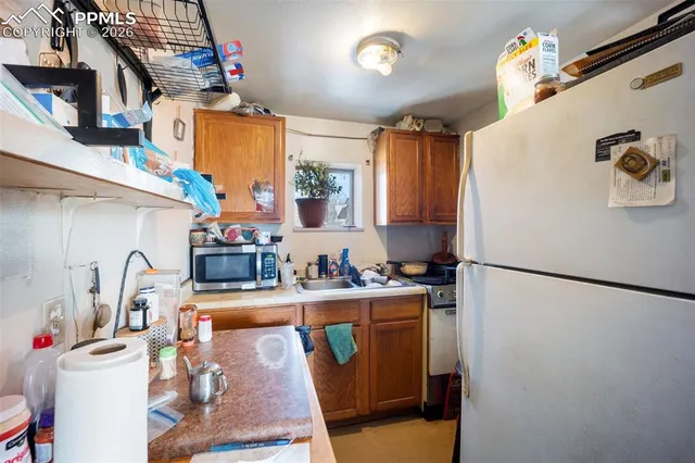 a kitchen with a refrigerator and a sink