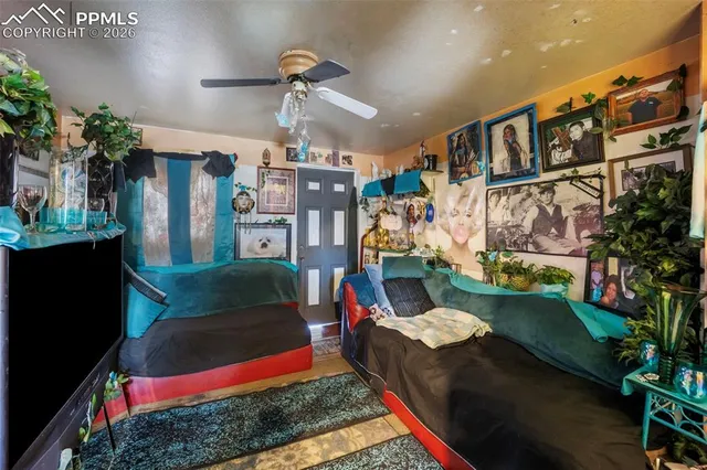 a living room with patio furniture and a floor to ceiling window