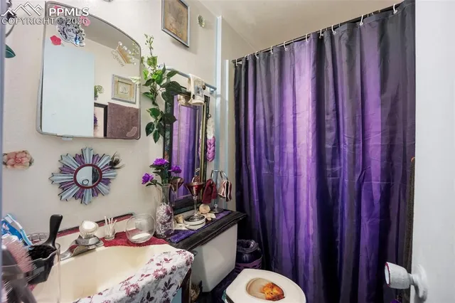 a bathroom with a sink vanity mirror and toilet