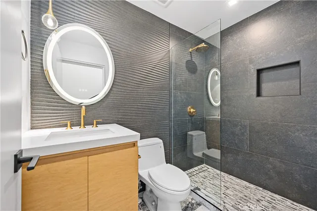 a bathroom with a toilet a sink and mirror