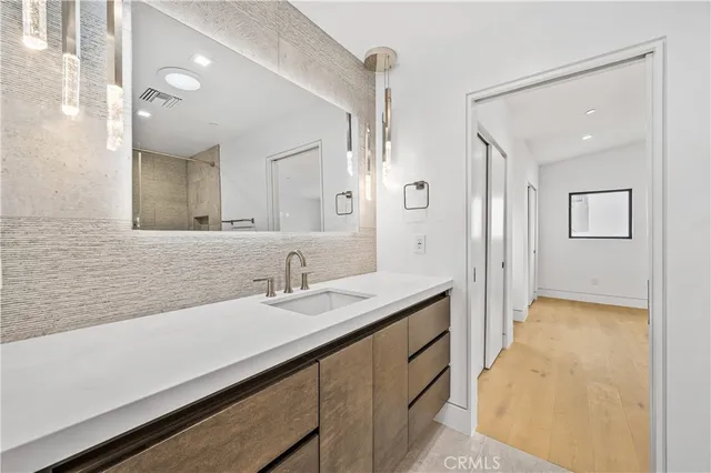a en suite bathroom with a sink double vanity and a mirror
