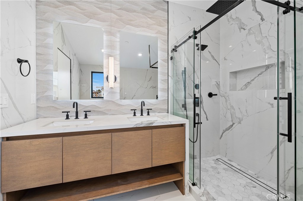 121 39th Street, Unit B Newport Beach, CA 92663 - Photo 19 of 26 a bathroom with a double vanity sink mirror and shower