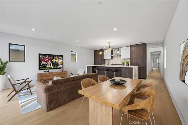 a view of a dining room with furniture and a flat screen tv