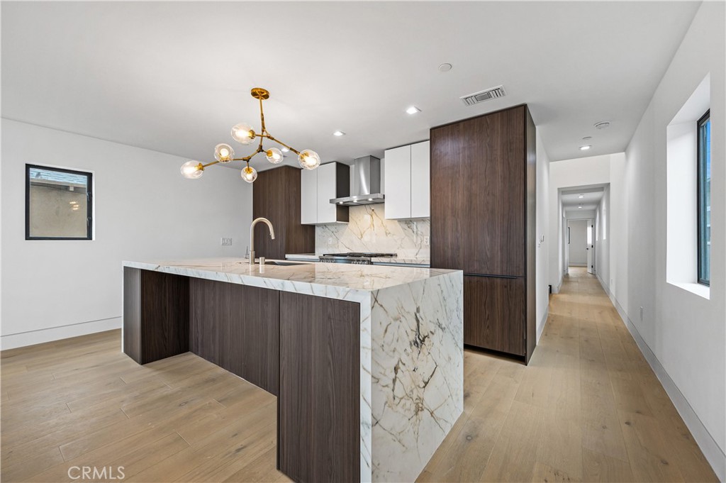 121 39th Street, Unit B Newport Beach, CA 92663 - Photo 6 of 26 a kitchen with stainless steel appliances granite countertop a refrigerator and a sink