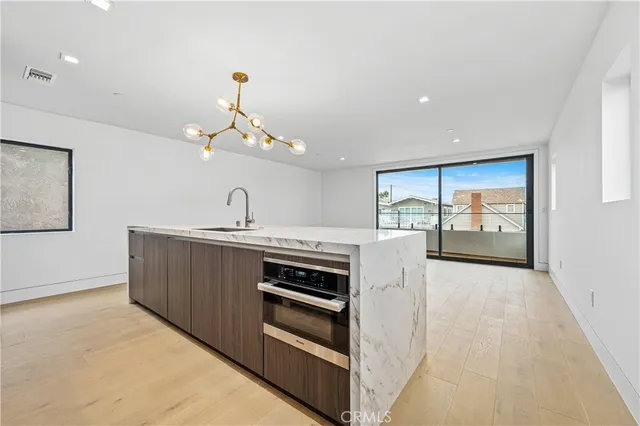 a kitchen with a sink and a stove top oven