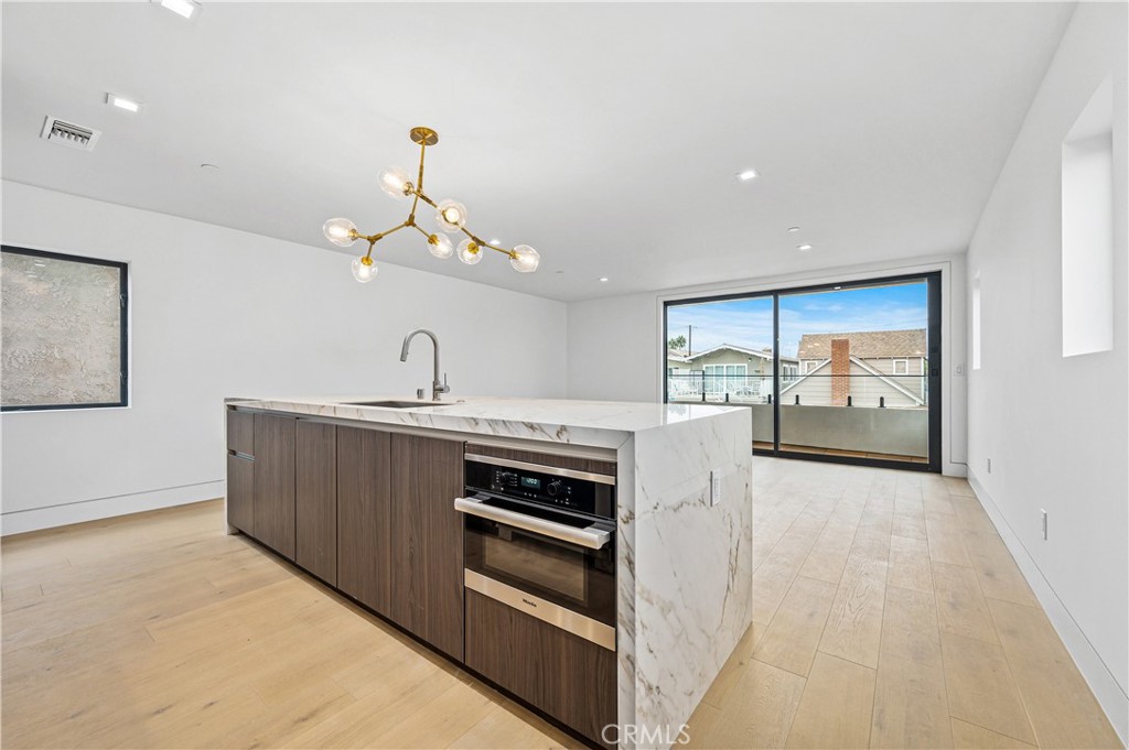 121 39th Street, Unit B Newport Beach, CA 92663 - Photo 7 of 26 a kitchen with a sink and a stove top oven