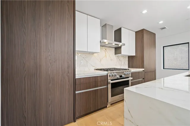a kitchen with stainless steel appliances granite countertop a stove and a refrigerator
