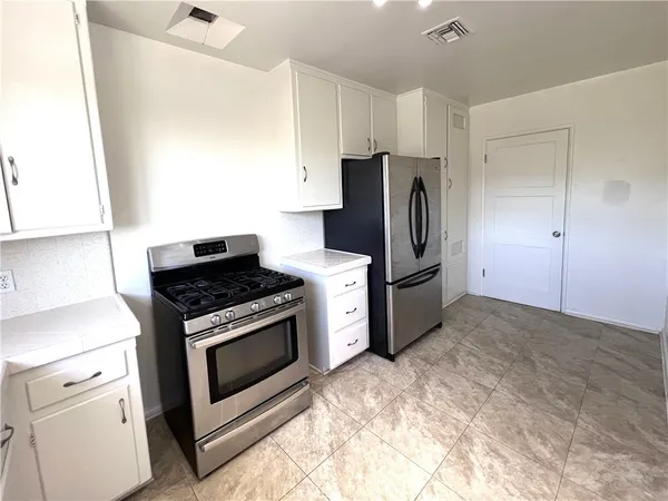 a kitchen with a stove microwave and refrigerator