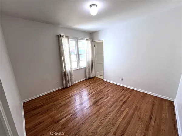 a view of room with wooden floor