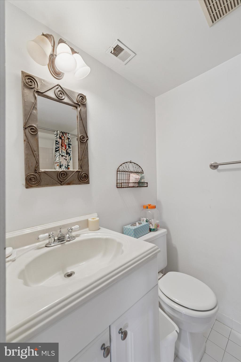 1 Christian Street, Unit 8 Philadelphia, PA 19147 - Photo 14 of 17 a bathroom with a sink toilet and mirror