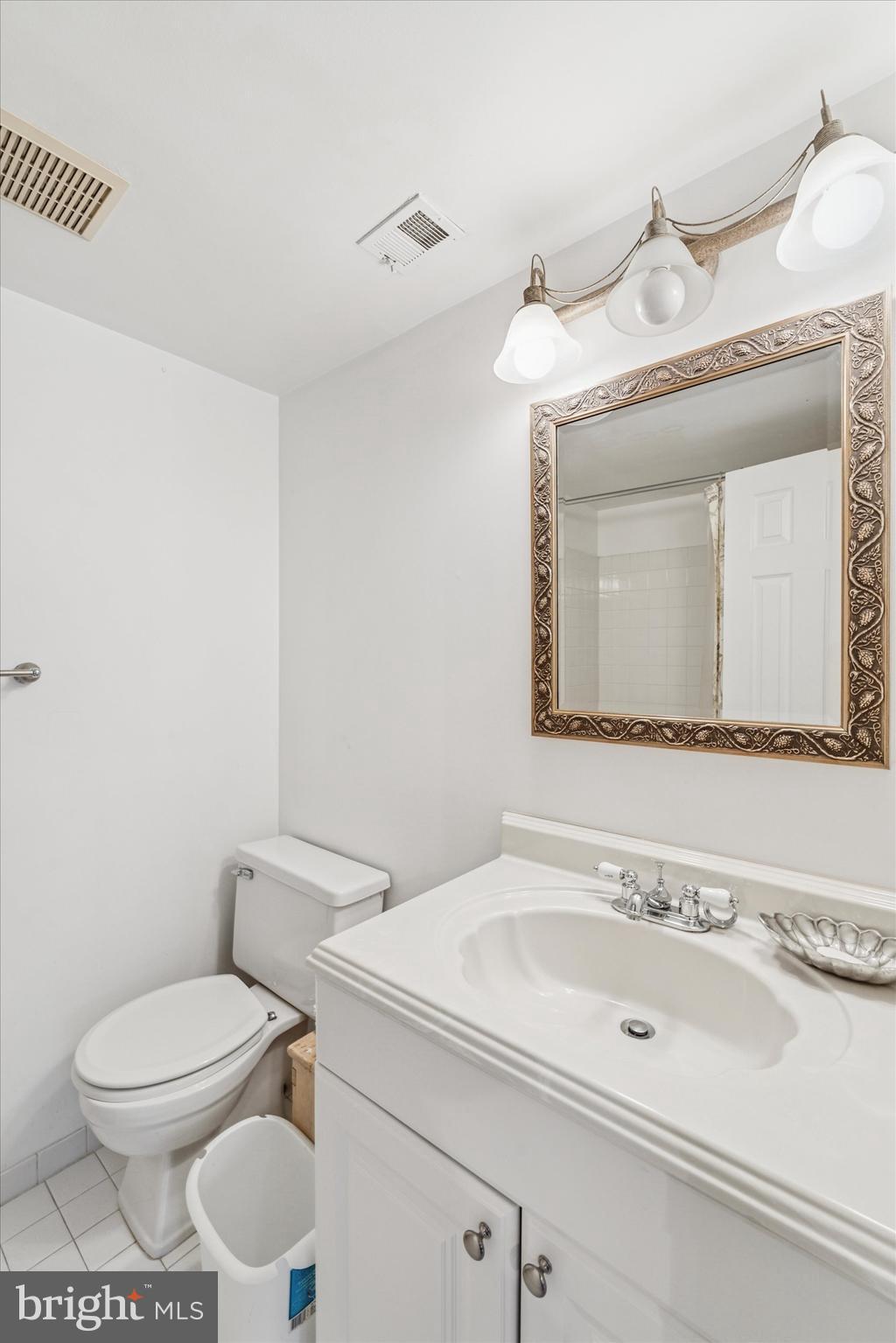 1 Christian Street, Unit 8 Philadelphia, PA 19147 - Photo 16 of 17 a bathroom with a toilet a sink and mirror