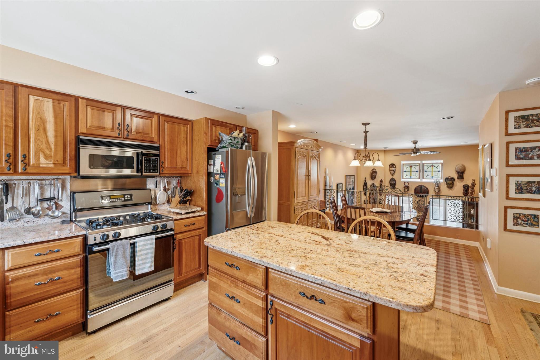 1 Christian Street, Unit 8 Philadelphia, PA 19147 - Photo 5 of 17 a kitchen with stainless steel appliances kitchen island granite countertop a stove and cabinets