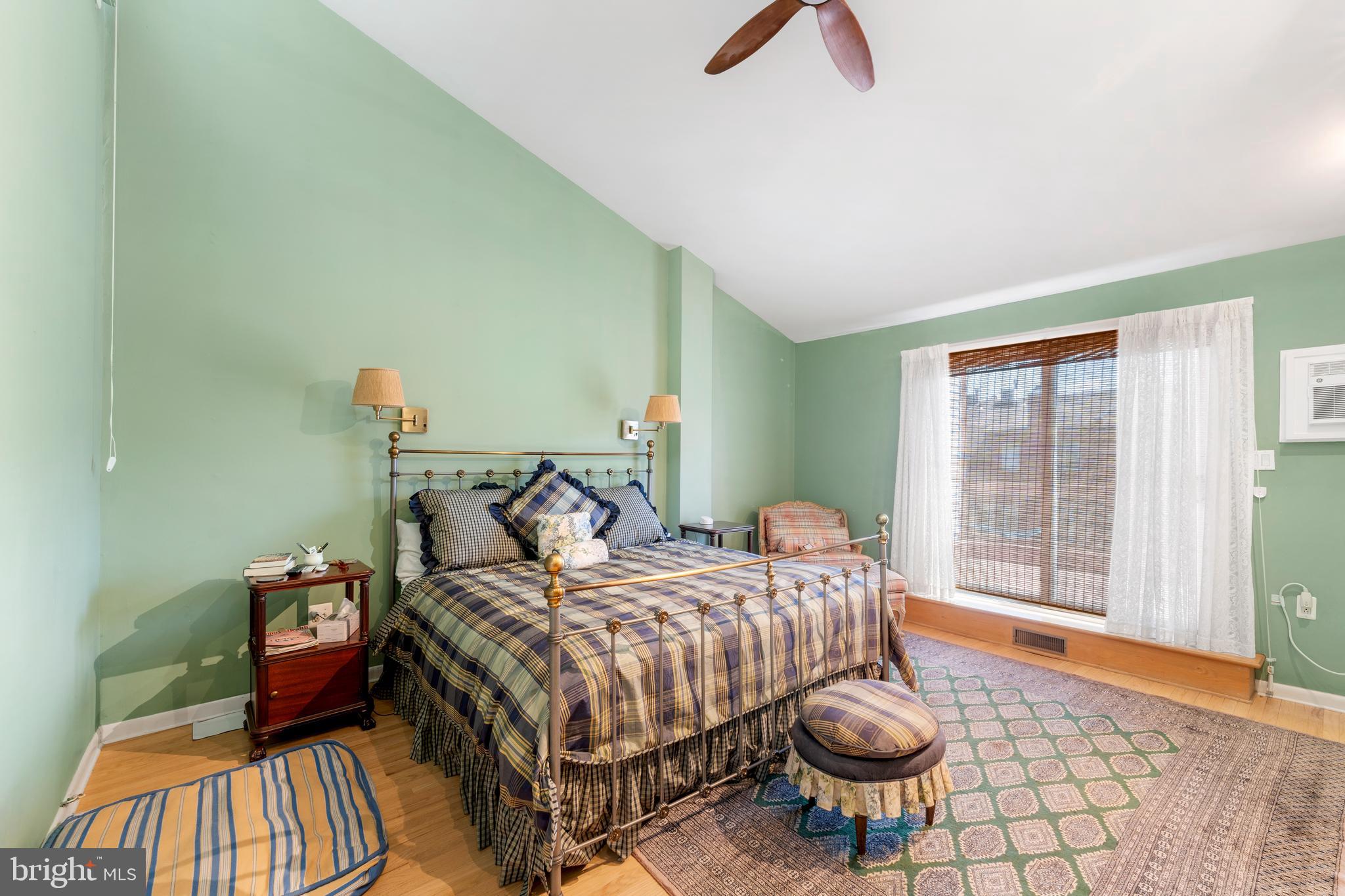 1 Christian Street, Unit 8 Philadelphia, PA 19147 - Photo 9 of 17 a bedroom with a bed and a large window