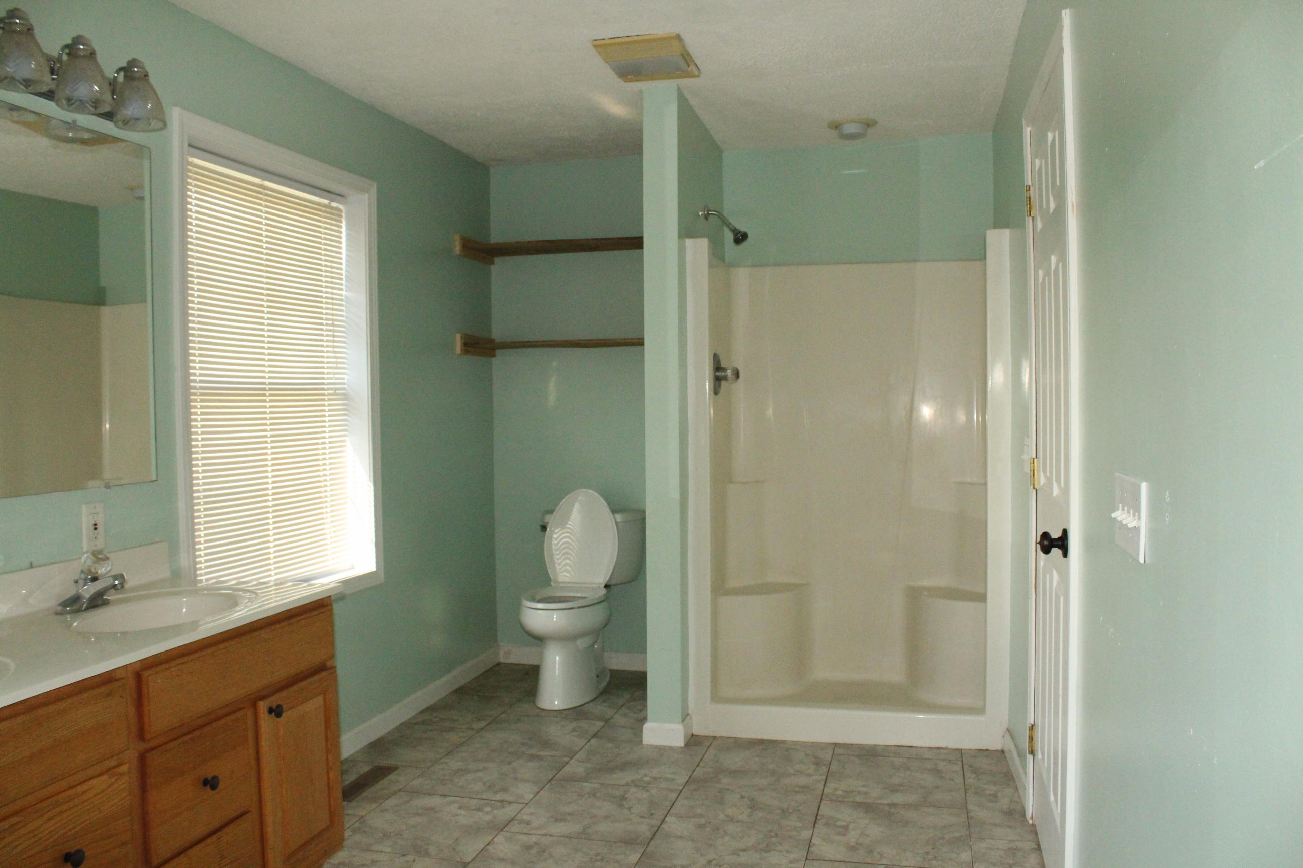 2670 Old Rte 100 Draper, VA 24324 - Photo 14 of 37 a bathroom with a granite countertop sink toilet and shower