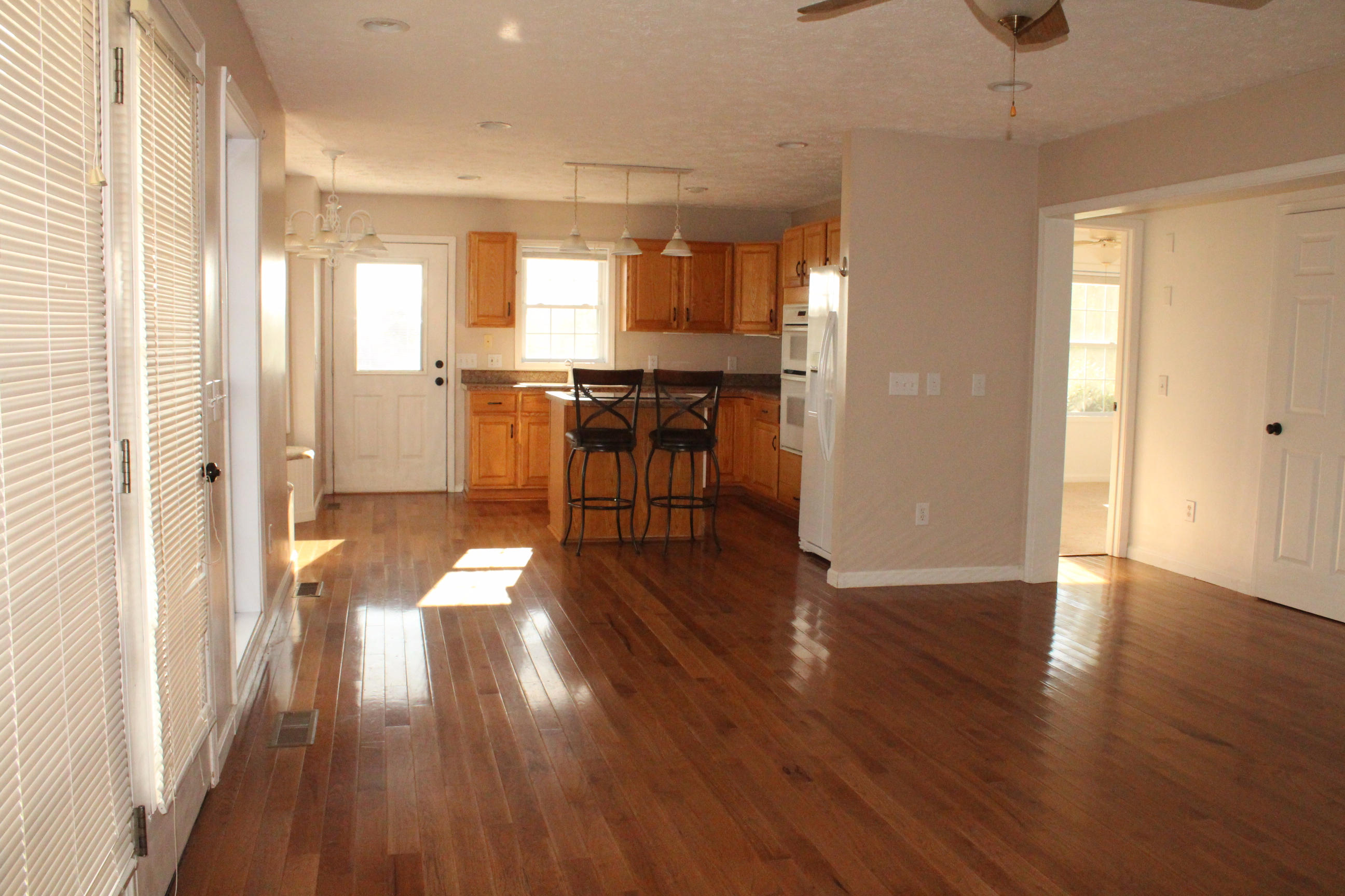 2670 Old Rte 100 Draper, VA 24324 - Photo 4 of 37 a view of a hallway with wooden floor a refrigerator and a window