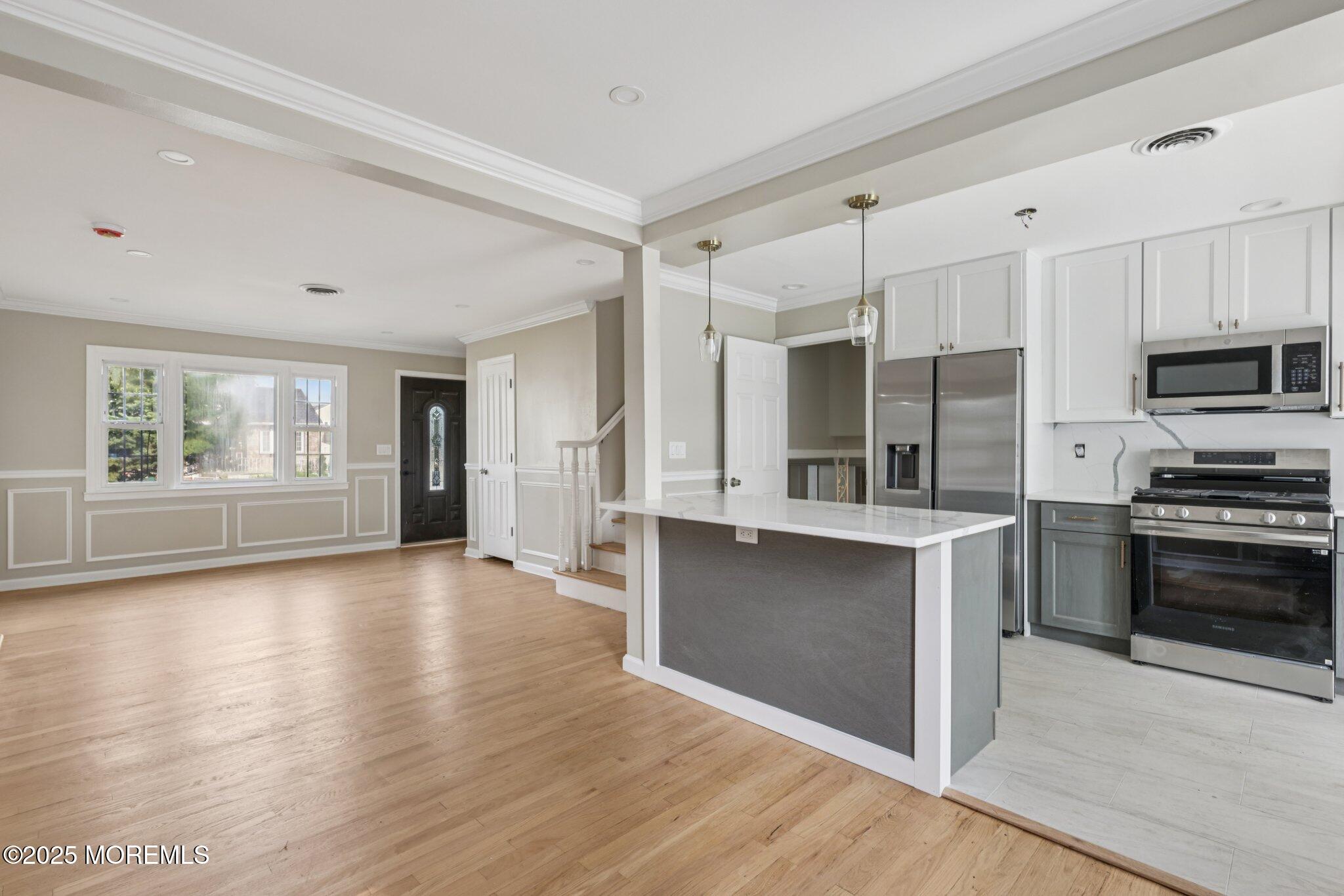 26 Fillmore Avenue Carteret, NJ 07008 - Photo 7 of 60 a kitchen with stainless steel appliances a stove top oven a sink and a refrigerator