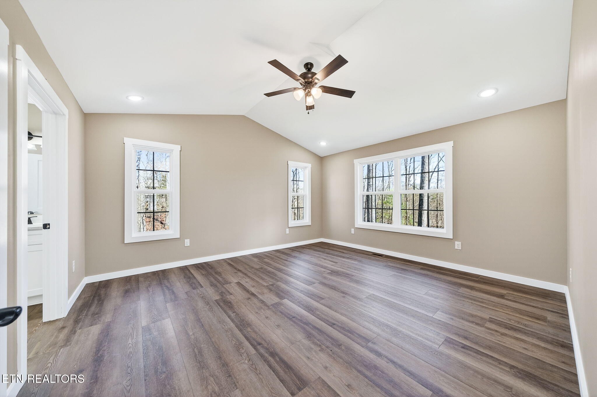 105 Peebles Road Crossville, TN 38558 - Photo 16 of 40 a view of an empty room with wooden floor and a window